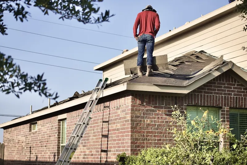 Professional roofer working on a residential roof in Old Irving Park